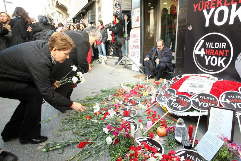 People leave flowers outside the offices of Agos newspaper where Hrant Dink was killed in 2007. Dink's family had long called for an investigation into the police's role in the murder.