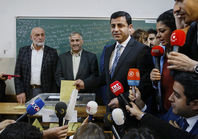 Selahattin Demirtaş, center, co-chair of the Peoples' Democratic Party, (HDP), casts his vote in Istanbul (AP Photo)