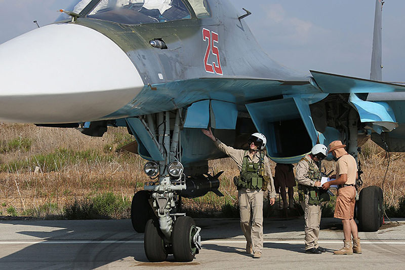 Russian pilots of SU-34 bomber checking their plane before the flight at the Syrian Hmeymim airbase, outside Latakia, Syria (EPA photo)