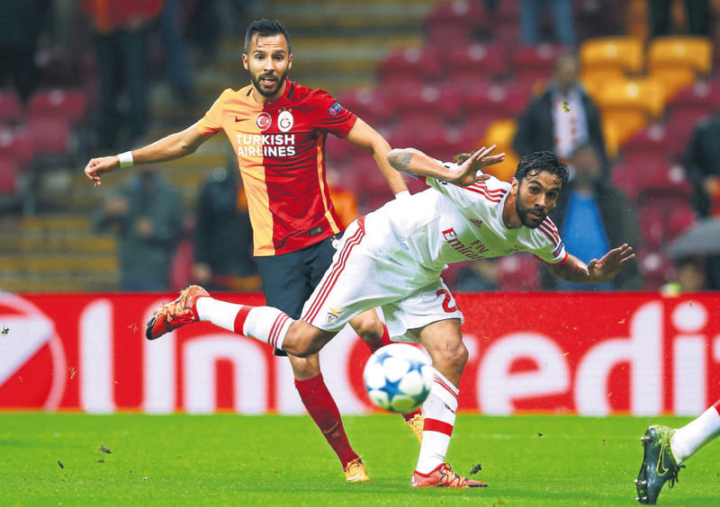 Galatasaray's Yasin Oztekin (L) is challenged by Benfica's Silvio during their Champions League Group C match at the Ali Sami Yen stadium in Istanbul on Oct. 21.