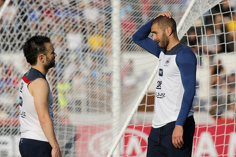 In this June 10, 2014 file photo, France's Mathieu Valbuena, left, and Karim Benzema, right, chat during a training session of the french national soccer team, at the Santa Cruz Stadium in Ribeirao Preto, Brazil (AP Photo)