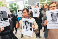 Protesters hold photos of NSU's victims outside a courthouse in Munich where Beate Zschaepe, the sole surviving member of the gang, stands trial.