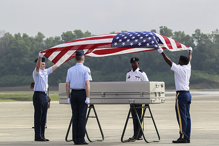 US military honor guards cover with the US flag a coffin containing human remains recoved from the crash in Subang, Malaysia (EPA Photo)