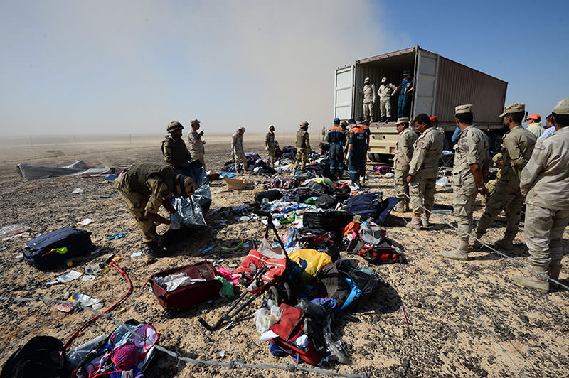 In this Monday, Nov. 2, 2015 file photo provided by Russian Ministry for Emergency Situations, Egyptian soldiers collect personal belongings of plane crash victims (AP photo)