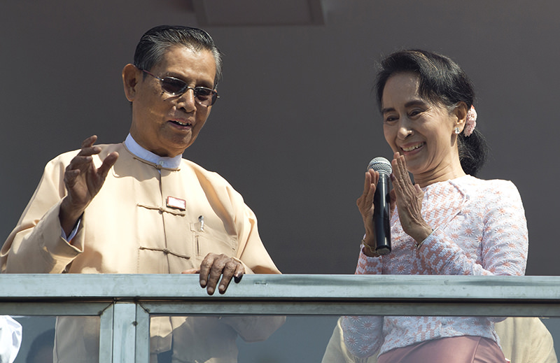 Leader of Myanmar's National League for Democracy party, Aung San Suu Kyi, delivers a speech with party patron Tin Oo from a balcony of her party's headquarters in Yangon, Myanmar (AP Photo)