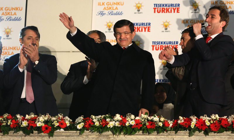 Prime Minister Ahmet Davutou011flu waves to supporters from the balcony of AK Party headquarters in Ankara, which has become a tradition after the party's successive wins.