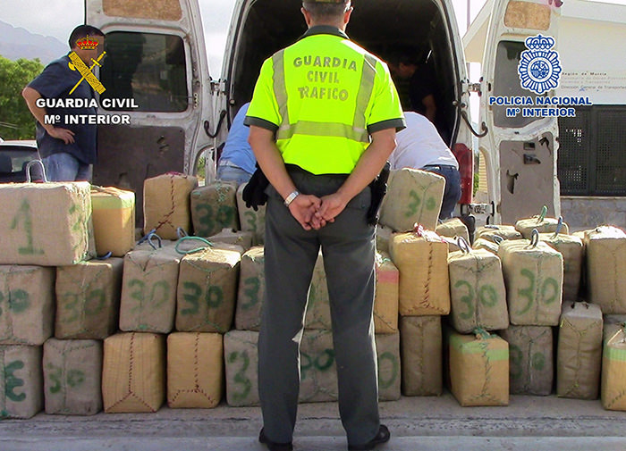 Spanish Home Ministry on 07 October 2015 shows a Spanish Civil Guard standing in front of packages containing hash in Murcia, southeastern Spain (EPA Photo)