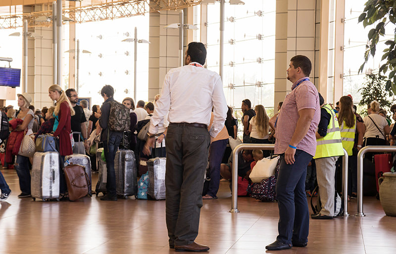 Travel company agents look at the line of tourists at the airport of Sharm el Sheikh, Egypt, on Saturday, Nov. 7, 2015. (AP Photo)