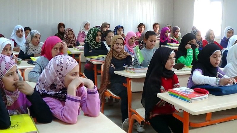 Syrian students at a school set up at a refugee camp near u015eanlu0131urfa. Most tent camps in the country house educational facilities.