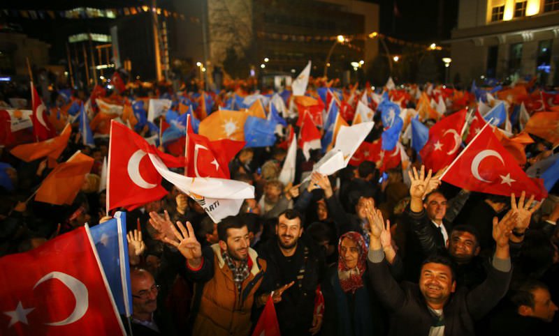 People wave flags outside the AK Party headquarters in Ankara after the party's victory in the Nov. 1 elections.