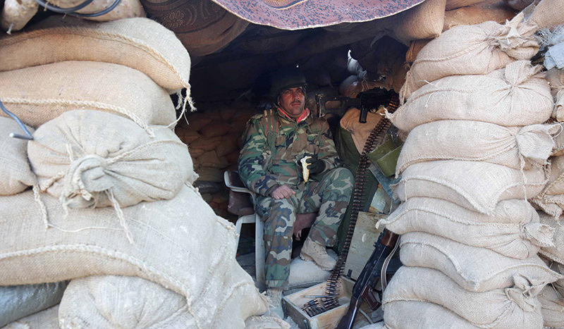 A Kurdish peshmerga fighter pauses during an operation to retake the northern Iraqi town of Sinjar on Thursday, Nov. 12, 2015. (AP Photo)