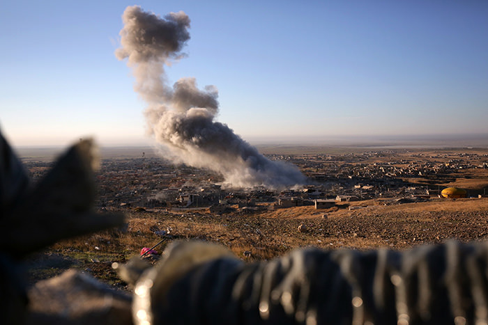 Smoke believed to be from an airstrike billows over the northern Iraqi town of Sinjar on Thursday, Nov. 12, 2015.