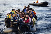 Migrants arrive on a dinghy to the Greek island of Lesbos, after crossing the Aegean Sea from Turkey on Saturday.