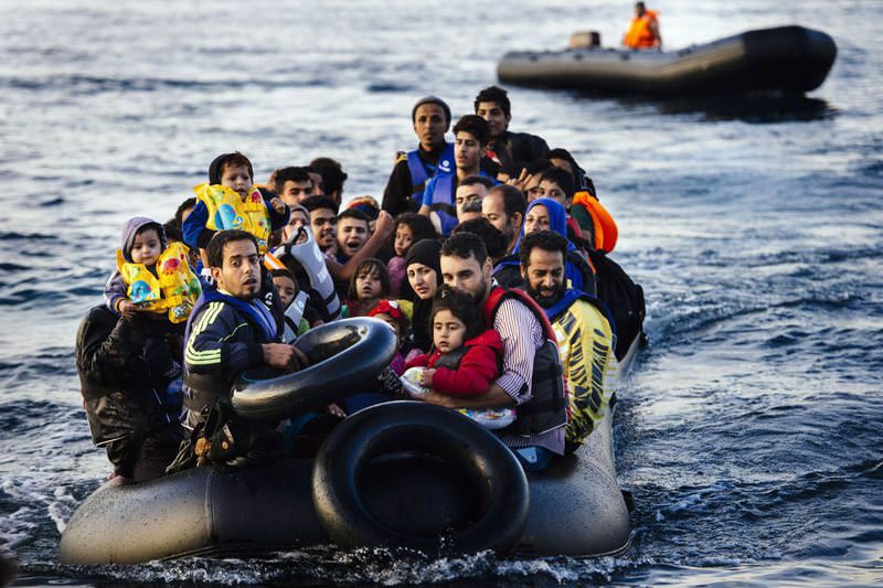 Migrants arrive on a dinghy to the Greek island of Lesbos, after crossing the Aegean Sea from Turkey on Saturday.