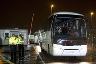 Syrian refugees are driven away in a convoy of buses after landing at Glasgow airport, Scotland on November 17, 2015 (AFP Photo)