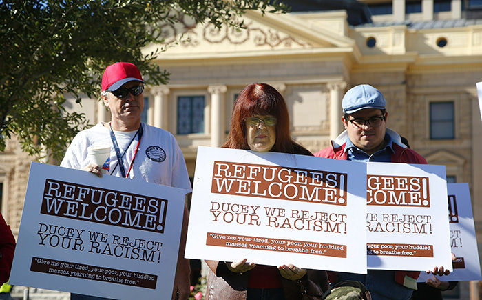Supporters for the welcoming of Syrian refugees pause during a rally at the Arizona Capitol Tuesday, Nov. 17, 2015, in Phoenix. (AP Photo)