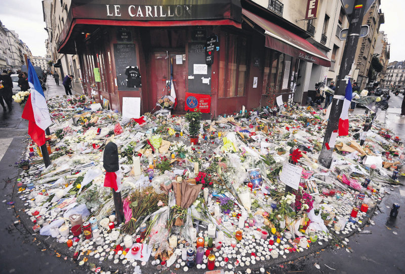 Flowers and candle tributes are placed at the Restaurant Le Carillon in Paris, after last Friday's attacks. 