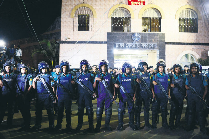 Bangladeshi police officers stand guard at Dhaka's Central Jail.