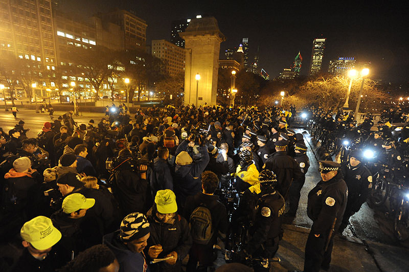 Chicago Police form a line to keep a protest for 17-year-old Laquan McDonald from entering Grant Park, early Wednesday, Nov. 25, 2015 (AP Photo)