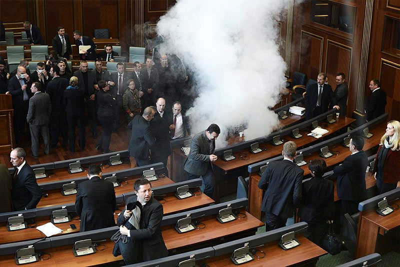 Opposition lawmakers throw tear gas during a session of Kosovo's parliament in Pristina, Kosovo, 30 November 2015 (EPA photo)