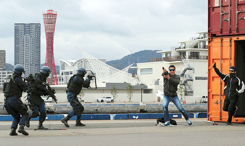 In this Thursday, Nov. 19, 2015 photo, riot police of Hyogo Prefectural Police, left, take positions against ,armed terrorists, performed by police officers during an anti-terror drill at a port in Kobe, western Japan (AP Photo)