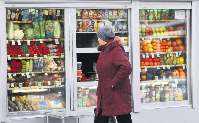 A Russian woman peers through a window to view fruits and vegetables at a street side market in Moscow. The Russian government banned fruits and vegetables imported from Turkey.