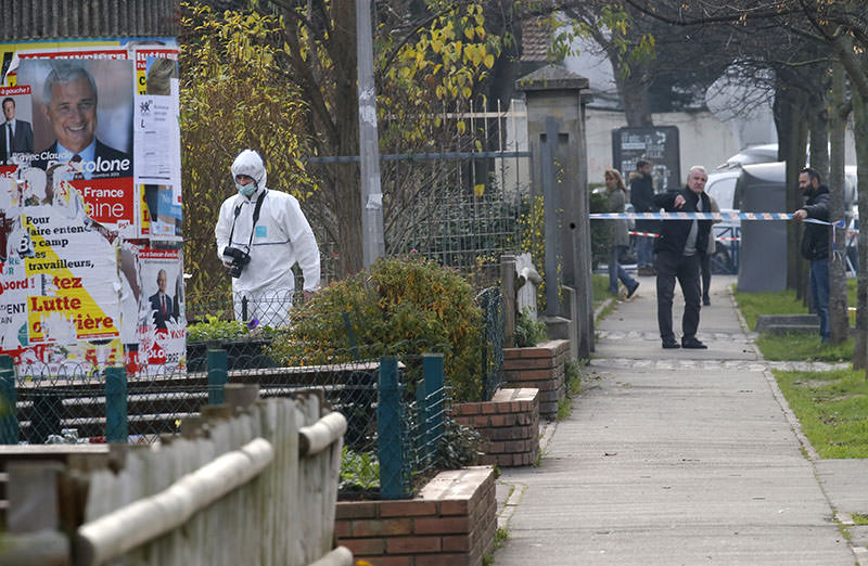 A forensic expert is seen outside Jean-Perrin nursery school in Aubervilliers (AP photo)