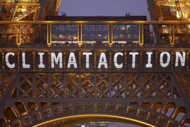 The slogan ''Climate action'' is projected on the Eiffel Tower as part of the World Climate Change Conference 2015 in Paris, December 11, 2015. (REUTERS Photo)