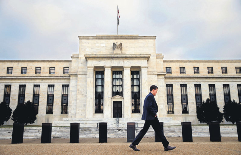 A man walks past the Federal Reserve in Washington.