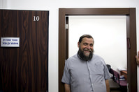 Benzion Gopshtein, leader of the far-right Israeli group Lehava, stands inside his lawyer's office before a news conference in Jerusalem, in this August 11, 2015 (Reuters Photo)