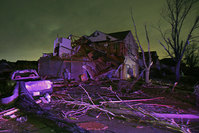 Debris lies on the ground near a home that was heavily damaged by a tornado in Rowlett, Texas (AP Photo)