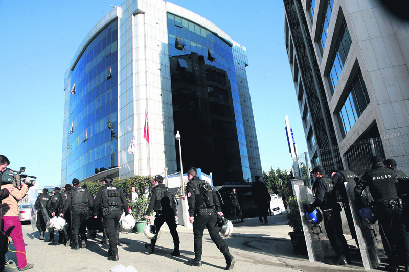 Police officers are seen outside Kaynak Holding's headquarters in this November photo. The conglomerate is accused of financing the FETu00d6 / PDY charged with terrorism.