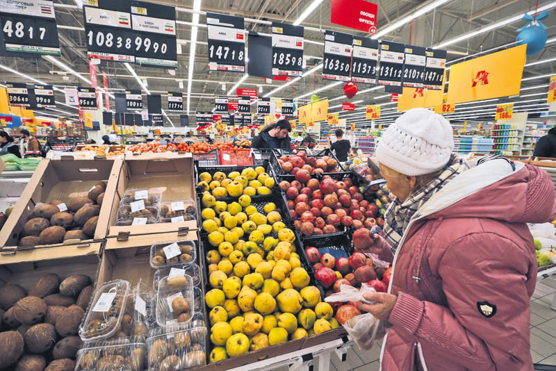 A Russian woman selects Turkish fruits at a supermarket in St. Petersburg. 