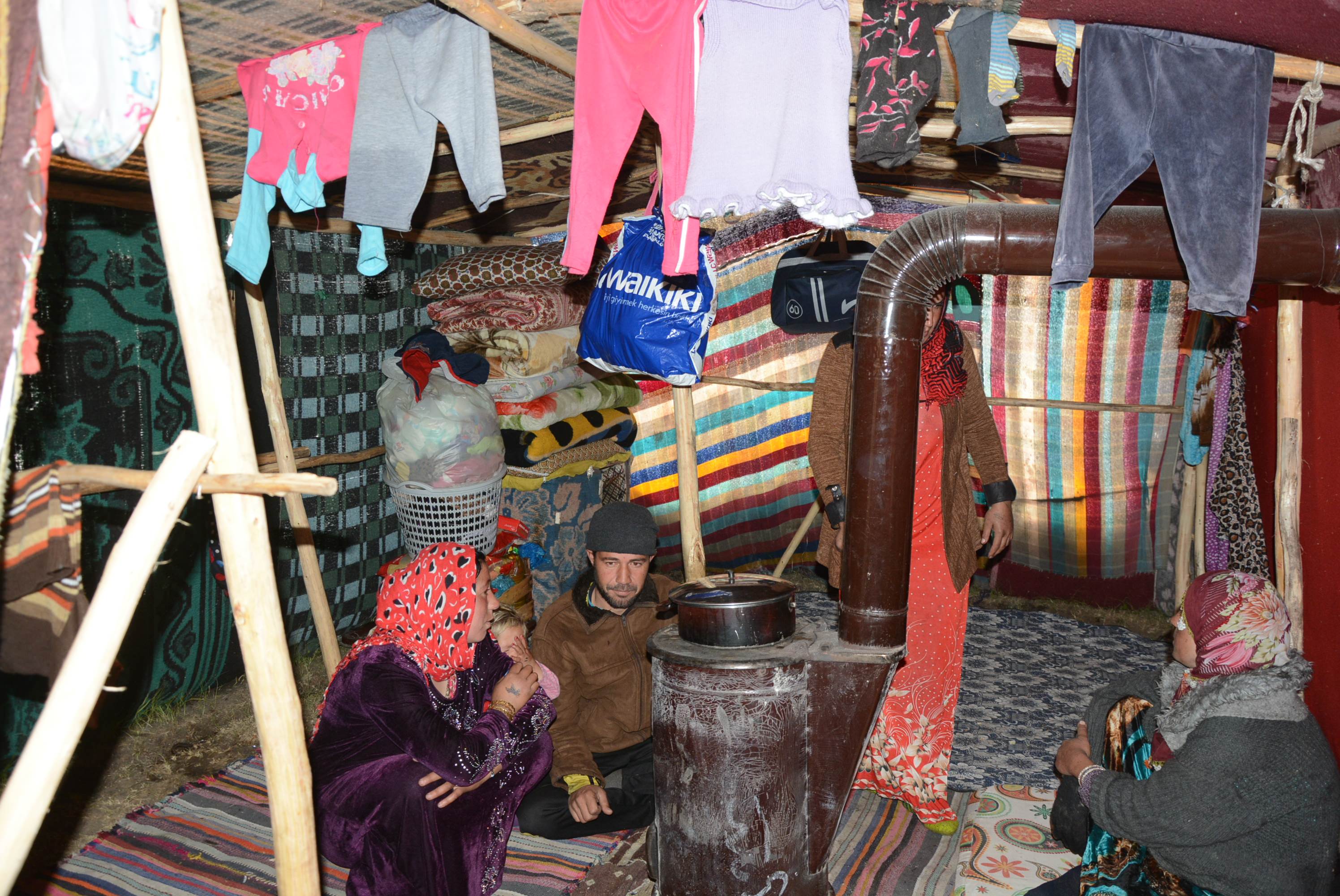 The family's tent was made out of blankets and they use a wood or coal burning stove to heat their shelter (AA Photo)