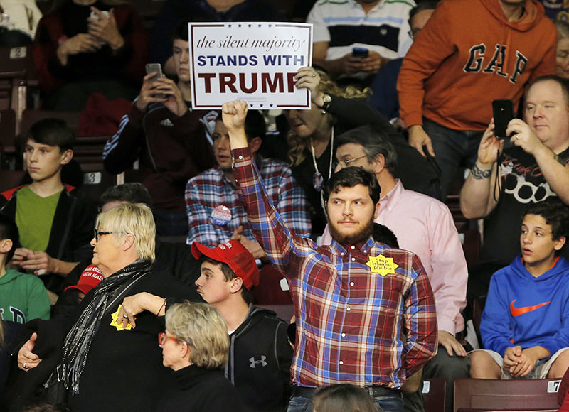 Another protester wearing a badge that reads 'Stop Islamophobia'