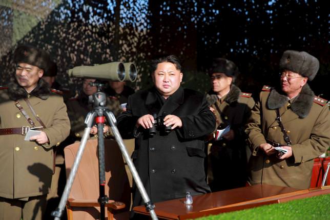 N. Korean leader Kim Jong Un (C) watches a firing contest of the KPA artillery units at undisclosed location on Jan 5, 2016. (REUTERS Photo)