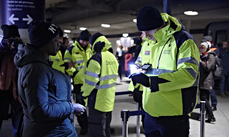 A passenger has her ID checked at the Copenhagen International Airport train station, the last stop before crossing the u00d6resund Bridge into Sweden. (AP Photo)