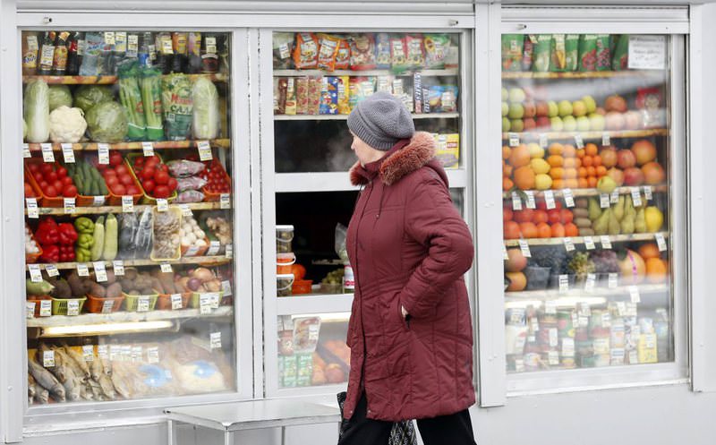 A Russian woman  looks at fruits and vegetables in a street market in Moscow. The Russian government is ready to ease sanctions imposed on Turkish goods.