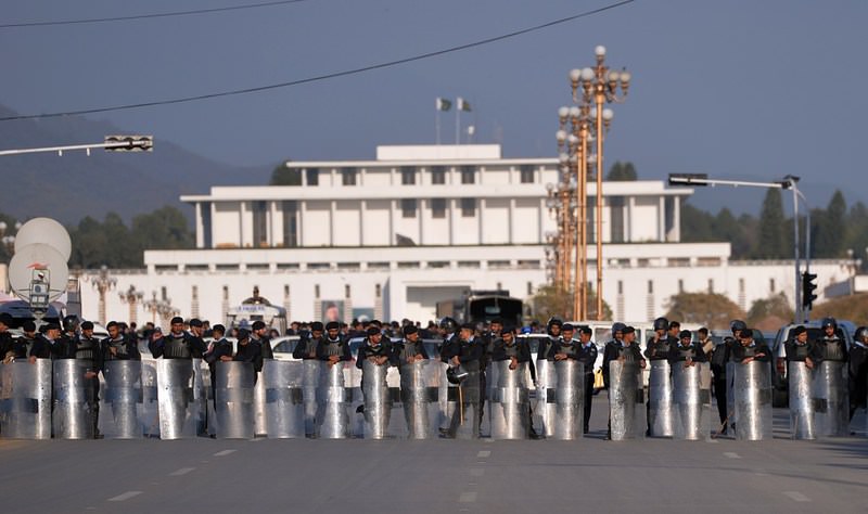 Pakistani riot police block a street leading to the President House during a protest by Shiite Muslims in Islamabad against the Pakistani government's decision to join a Saudi-led military coalition.