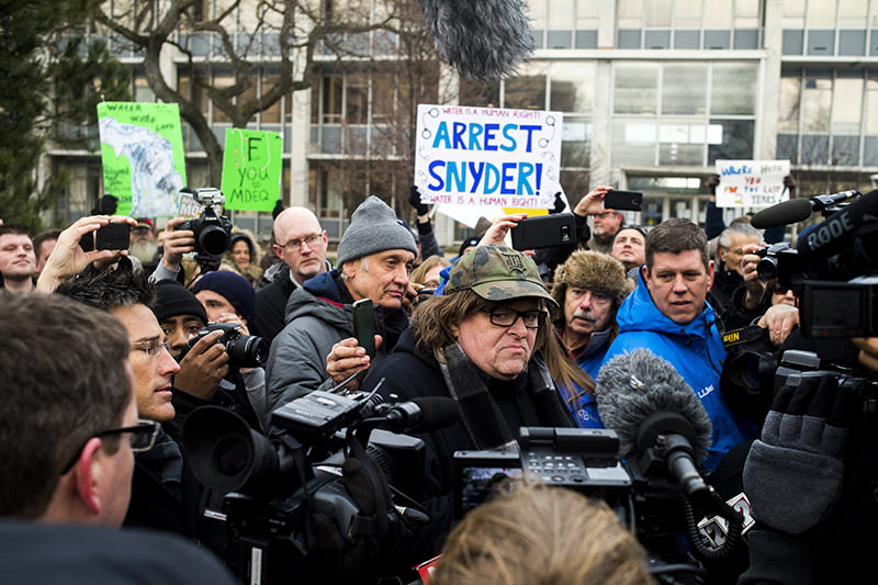 Flint native and and Oscar-winning documentary maker Michael Moore attends a rally outside city hall in Flint, on Saturday, Jan. 16, 2016, accusing Michigan Governor Rick Snyder of poisoning the city's water. (AP Photo)