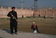 This photograph taken from a mobile phone shows Pakistani security personnel taking position outside the Bacha Khan university (AFP photo)