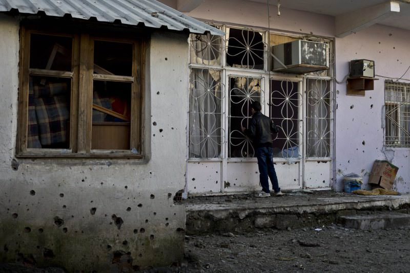 A Kurdish boy waiting outside a house riddled with bullet holes after clashes between security forces and the PKK in the Cizre district of southeastern u015eu0131rnak province.