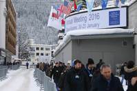 Attendees walk outside the Congress Center during the Annual Meeting 2016 of the World Economic Forum (WEF) in Davos, Switzerland yesterday.