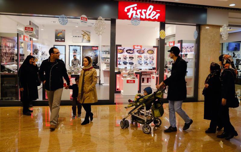 Iranians walk at a shopping center in Iranian capital Tehran. (EPA Photo)