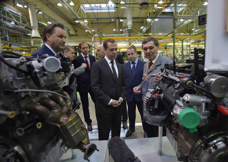 Russian Prime Minister Dmitry Medvedev (C) and AvtoVAZ president Bo Inge Andersson (L) visit the AvtoVAZ automobile plant in Togliatti, Russia (EPA Photo)
