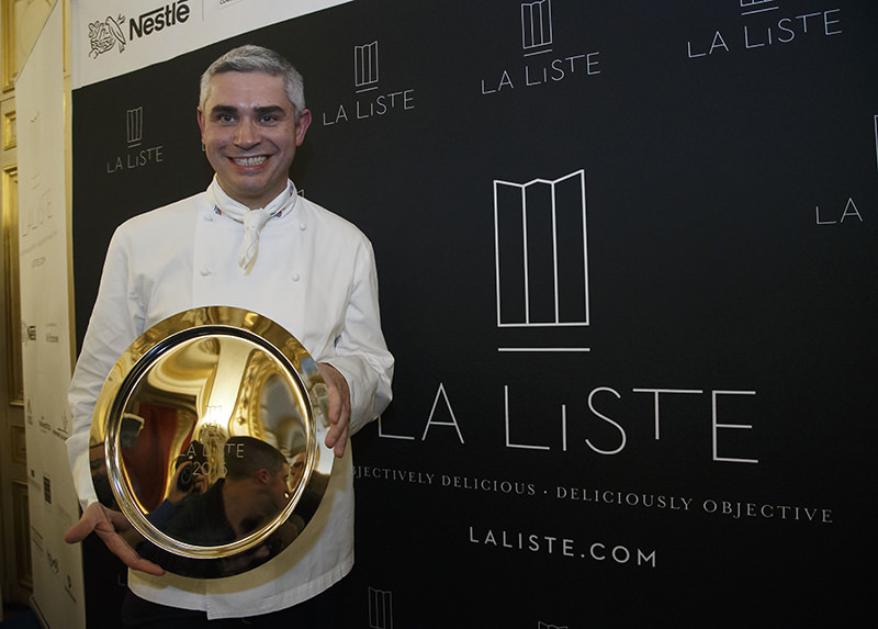 French Swiss Chef Benoit Violier of the restaurant Hotel de Ville in Crissier, Switzerland, poses with his trophy for the best restaurant of the World (AP Photo)