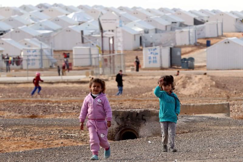 Syrian refugee children standing at the Azraq refugee camp in northern Jordan.