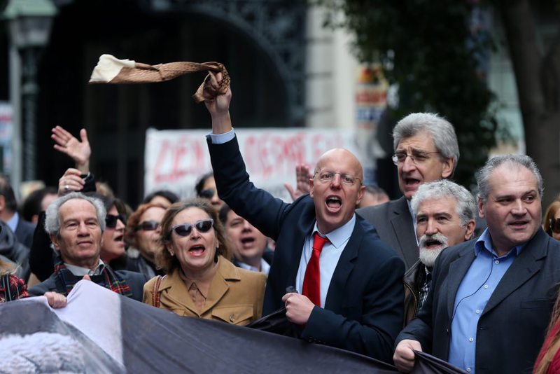 A lawyer waves his tie as others shout slogans during a 24-hour, nationwide general strike in Athens on Thursday.  (AP Photo)