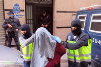 A handout picture released on February 7, 2016 by Spanish National Police shows masked police officers taking an arrested person at an undisclosed location. (AFP Photo)