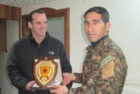 Obama's special envoy for the anti-DAESH coalition, Brett McGurk (L), with YPG militant Polat Can.